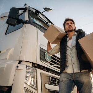 Shipping conception, with boxes. Truck driver is near the transport outdoors